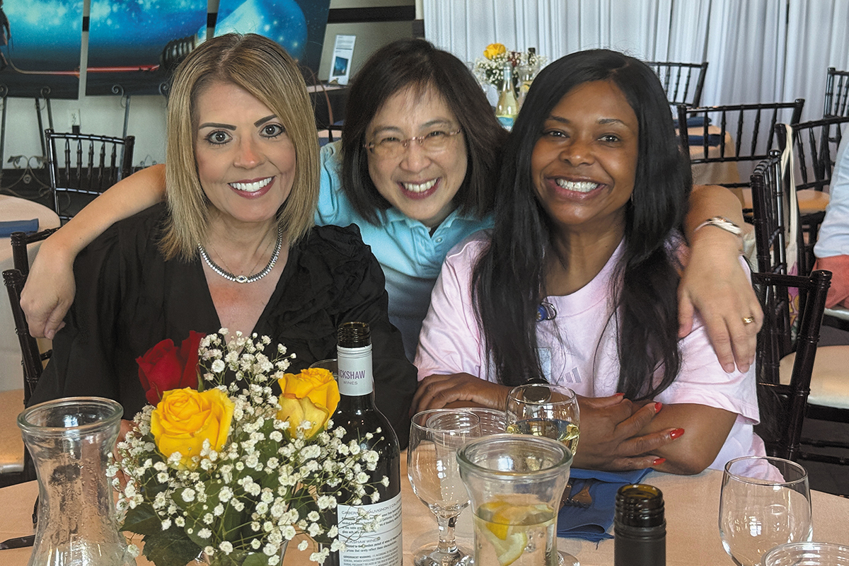 Three women smiling at camera