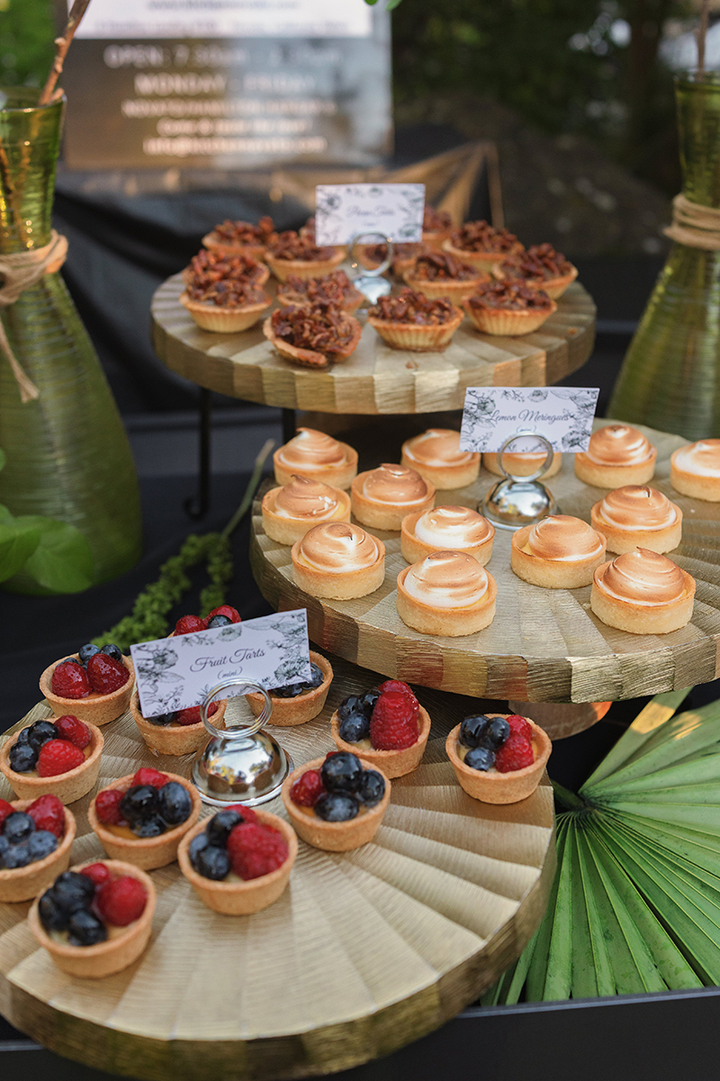 A table displaying an assortment of colorful desserts, including cakes, pastries, and fruit tarts.