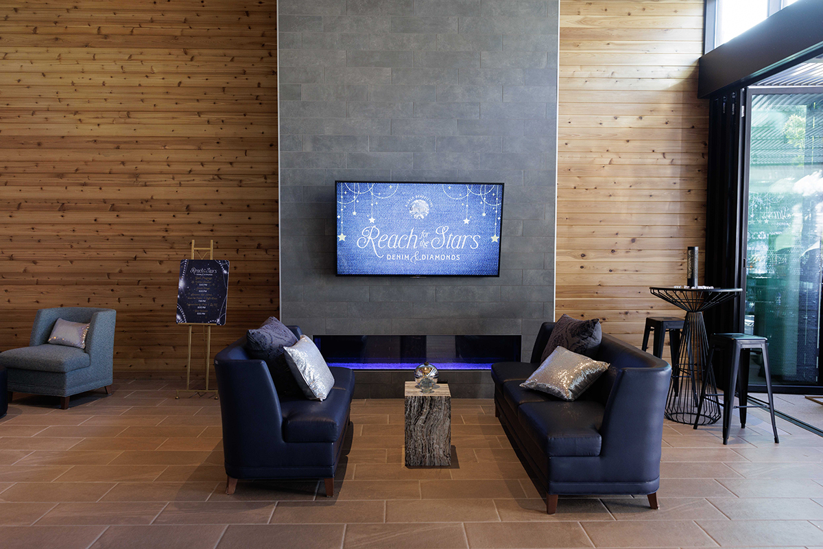 A lobby featuring a television and comfortable couches arranged for relaxation and entertainment.