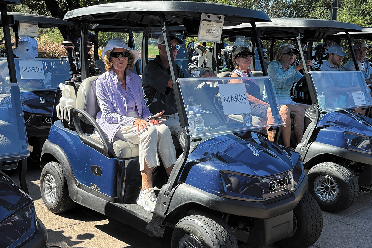 Men and women in golf carts