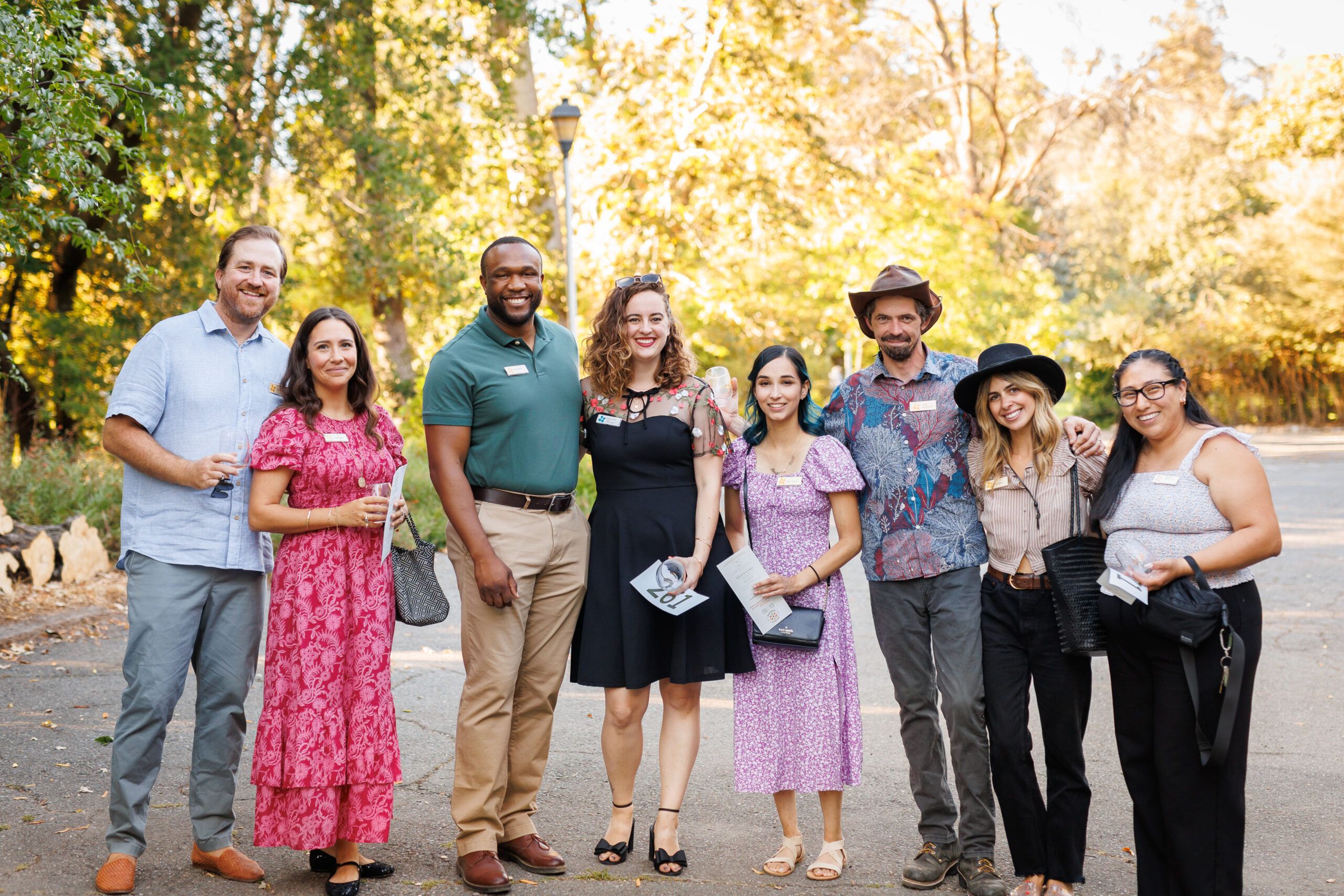 A large group of people stand outside.