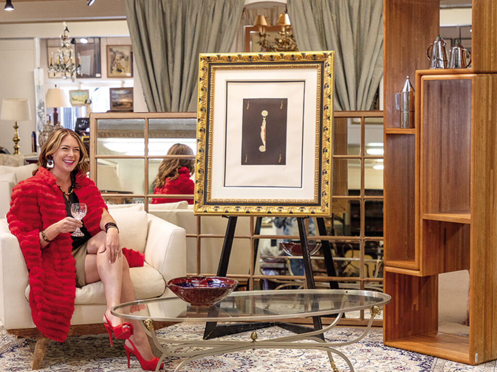 A woman comfortably sitting in a chair within a warmly decorated room.