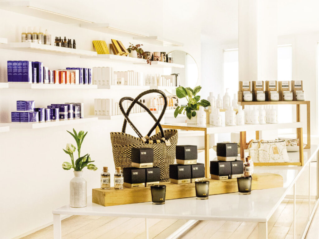 A white counter displaying a variety of products, including bottles, boxes, and containers.