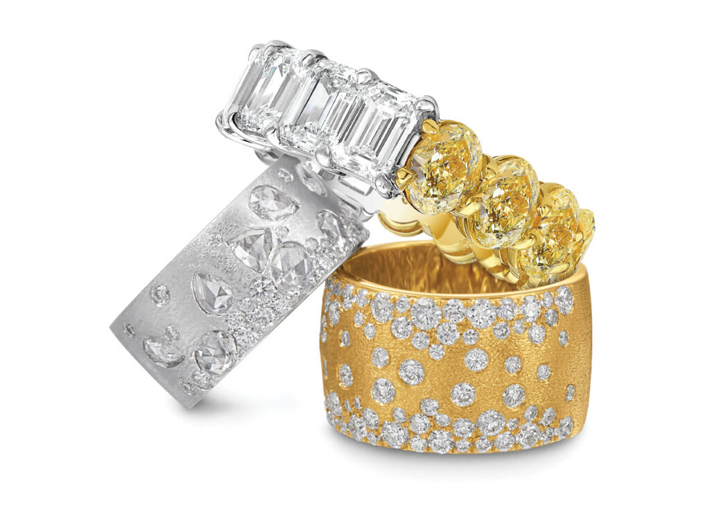 Three elegant rings featuring diamonds set in gold, showcasing a luxurious and sophisticated design.