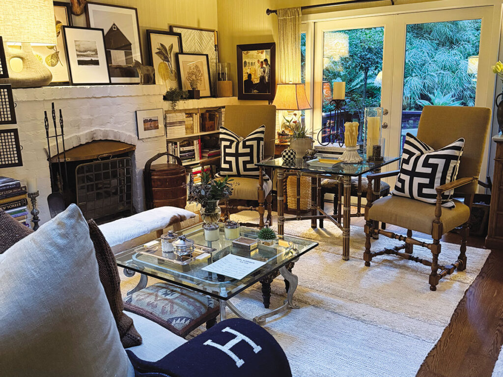 A cozy living room featuring a couch, chair, coffee table, and a warm fireplace.