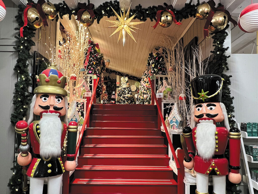 A beautifully decorated Christmas scene featuring nutcrackers, Christmas trees and a sparkling star