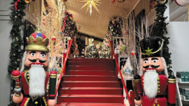 A beautifully decorated Christmas scene featuring nutcrackers, Christmas trees and a sparkling star