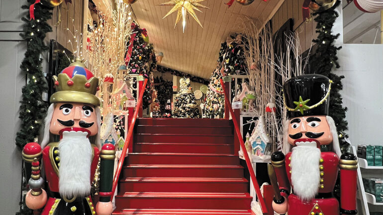 A beautifully decorated Christmas scene featuring nutcrackers, Christmas trees and a sparkling star
