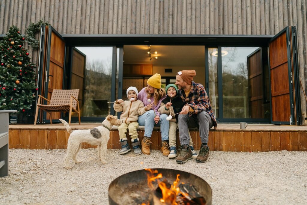 Trustr image of family by fireplace in front of contemporary house