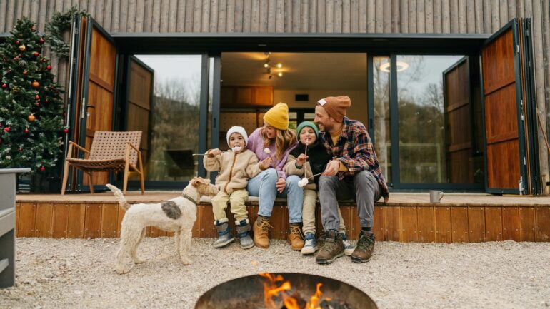 Trustr image of family by fireplace in front of contemporary house