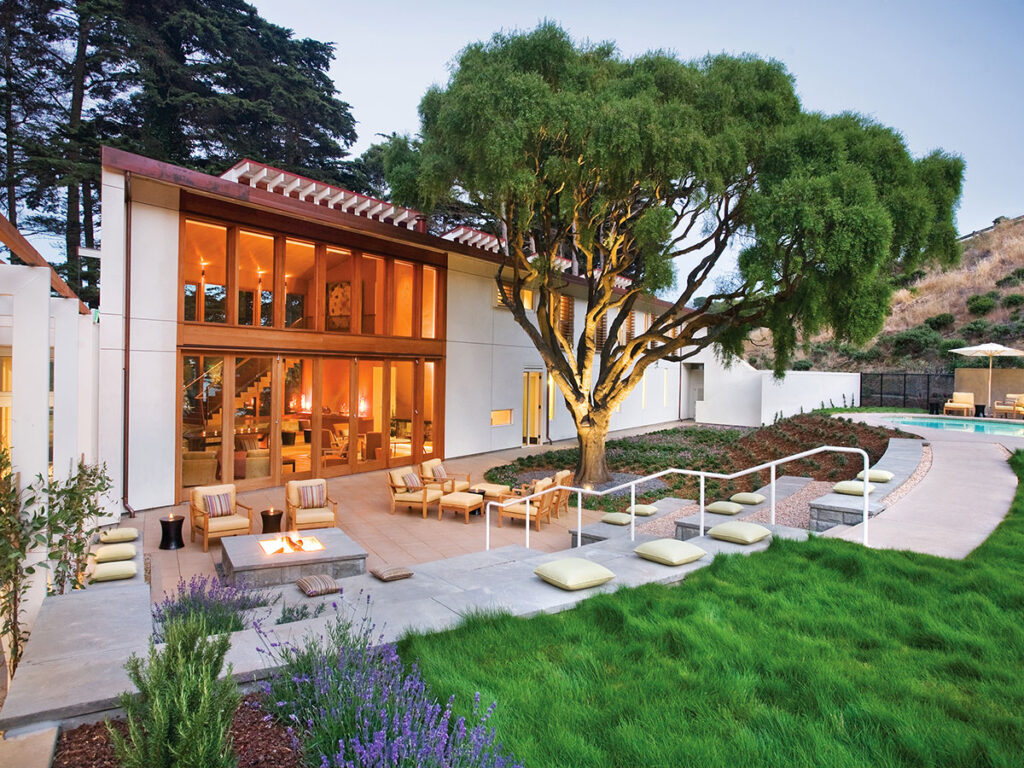 A contemporary home featuring a swimming pool and a spacious patio area for outdoor relaxation.