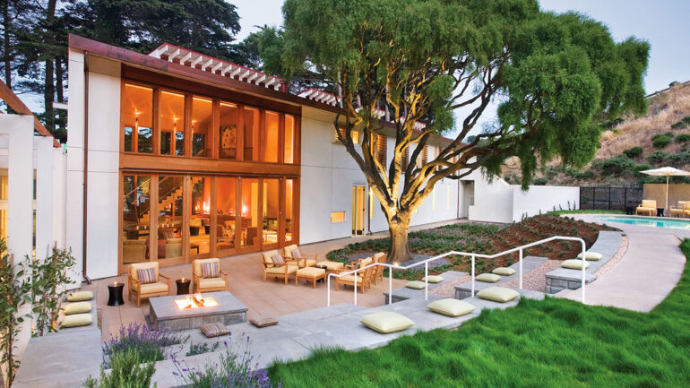 A contemporary home featuring a swimming pool and a spacious patio area for outdoor relaxation.