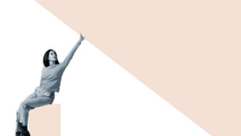 A woman in grayscale sits on a ledge, pointing upward with confidence. The background features a large beige triangle, creating a modern, dynamic feel.