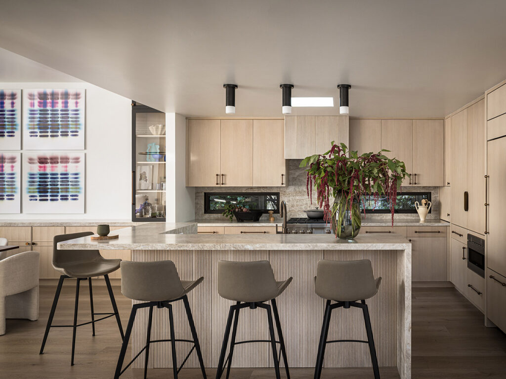 Belvedere waterfront home - The tambour paneling-clad island contains hidden storage