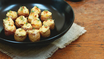 A cast iron pan with potato poppers