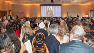 Guests engaged in By the Bay Health CEO Skelly Wingard's call to action, Credit Redel Frazier