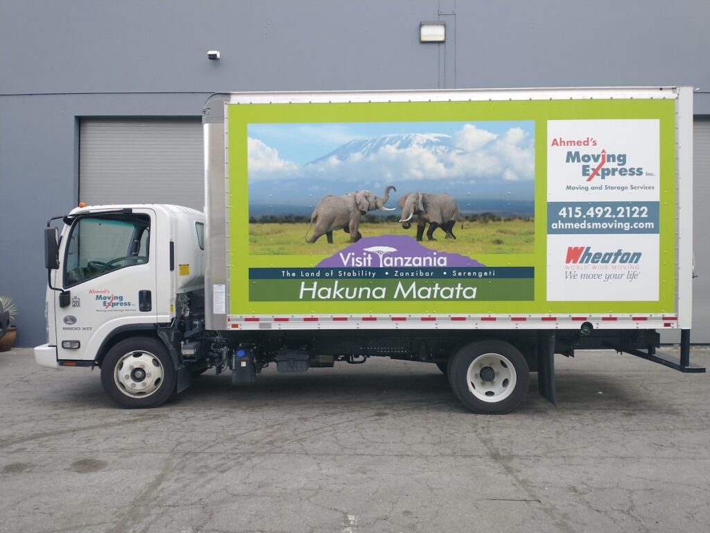 A moving van with Hakuna Matata featured on the side.