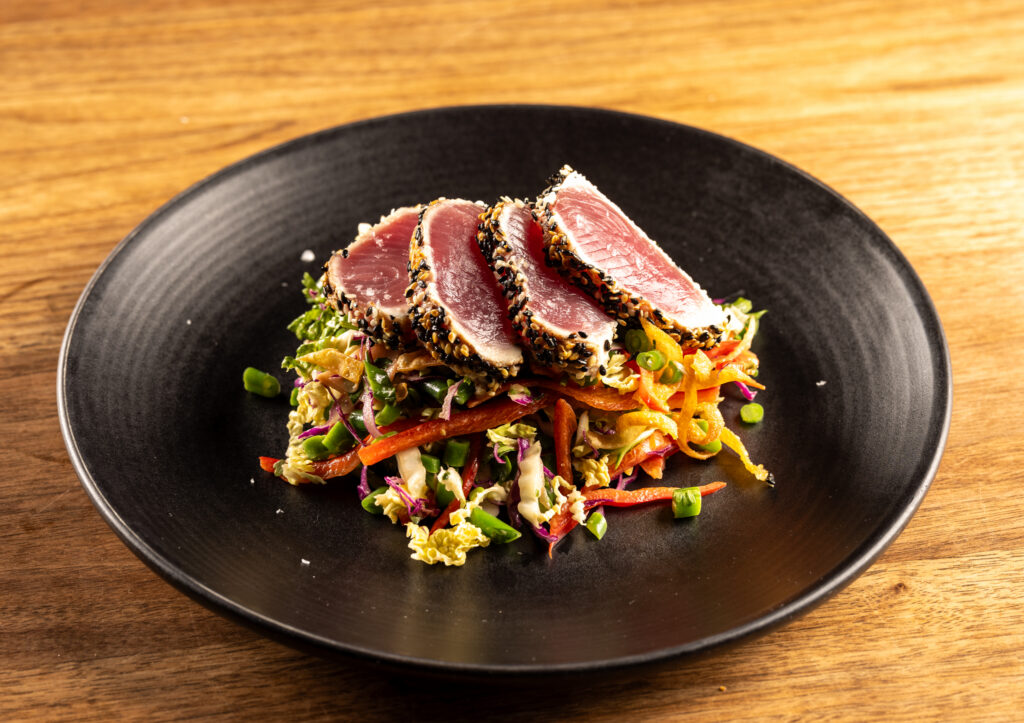 When we think of a steakhouse, we may picture a juicy red steak charred to perfection and paired with a big, bold red wine.