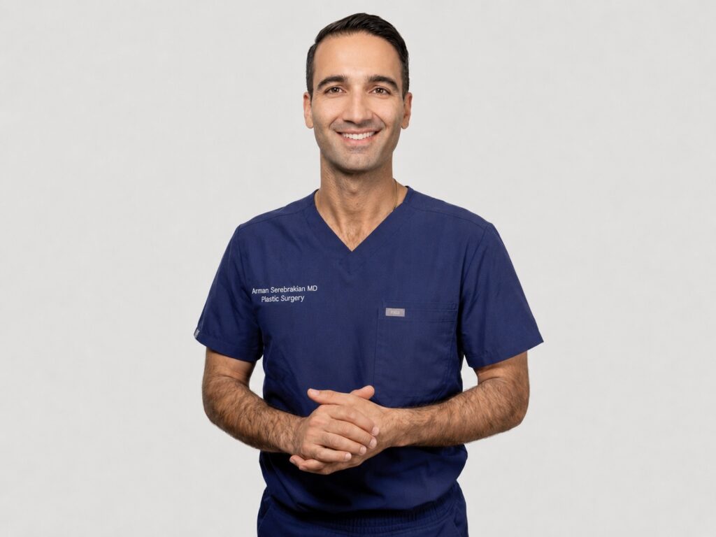 Dr. Arman Serebrakian is standing in front of a white background, smiling.