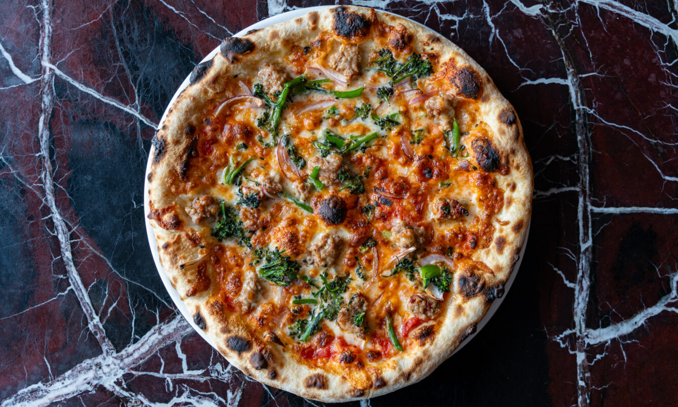 An image of a Margherita pizza taken from overhead.