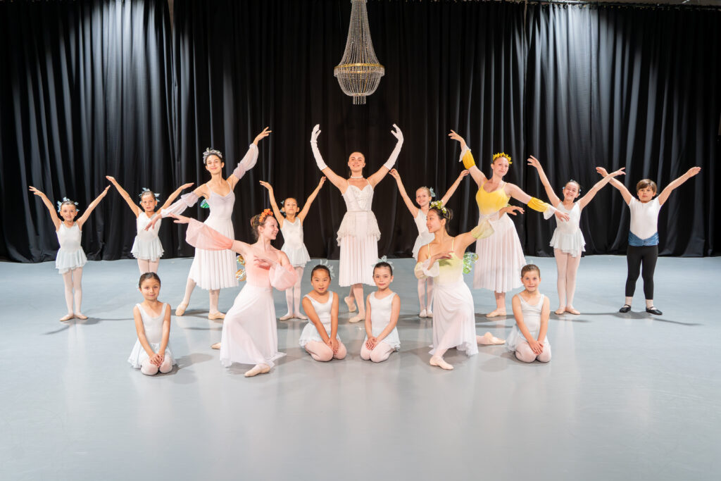 A group of ballerinas are center stage.