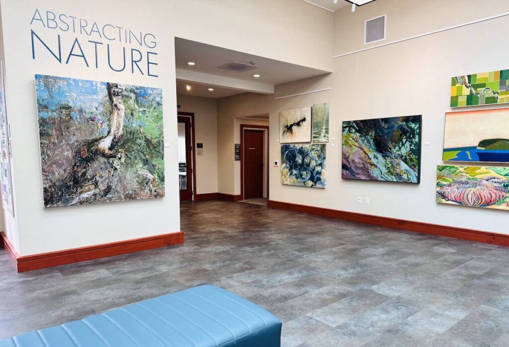 The interior of an art galley with art featured on the walls.