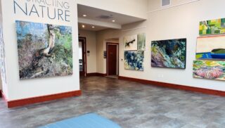 The interior of an art galley with art featured on the walls.