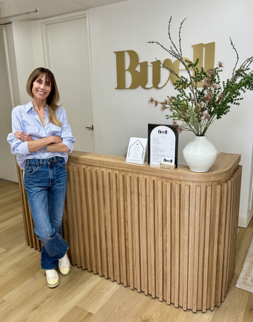 A woman standing by a desk