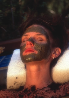 a woman wearing a mud mask