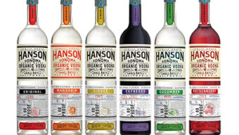 Six bottles of HANSON Organic Vodka are displayed in a row, each with a different flavor and colorful label. This selection of good vodka includes flavors from left to right: Original, Mandarin, Cucumber, Habañero, Meyer Lemon, and Ginger. Enjoy the taste of premium local vodka in every sip.