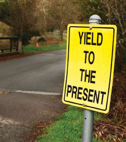 a sign that reads yield to the present 